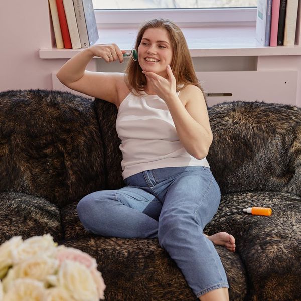 Person smiling and stretching gently in a bright, airy room.